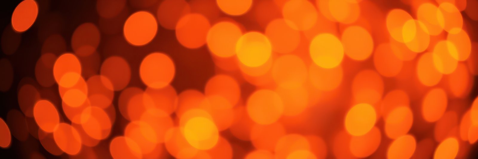 Bright orange bokeh lights create a warm and inviting atmosphere during an evening celebration